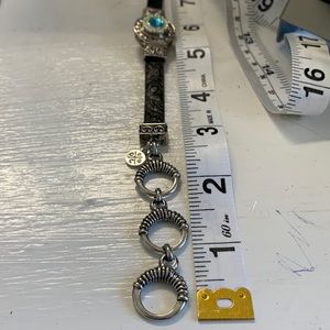 One black embossed leather toggle snap bracelet with one snap.  NWT